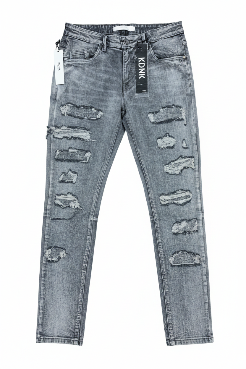 Distressed gray denim jeans on white background
